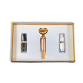 Skincare gift set with two serums and a roller device in a gold box